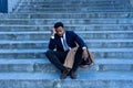 Sad business man suffering from depression in total despair hopeless and frustrated in city stairs Royalty Free Stock Photo