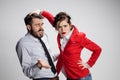 The sad business man and woman conflicting on a gray background Royalty Free Stock Photo