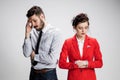 The sad business man and woman conflicting on a gray background Royalty Free Stock Photo