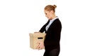 Sad business woman carrying box after loosing job