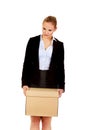 Sad business woman carrying box after loosing job