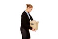 Sad business woman carrying box after loosing job