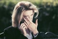 Sad business woman talking on cell phone in a city park Royalty Free Stock Photo