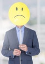 Sad businessman holding face against blurred bright background Royalty Free Stock Photo