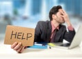 Sad businessman at office desk working on computer laptop asking for help depressed Royalty Free Stock Photo