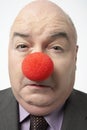 Sad Businessman Wearing Clown Nose Royalty Free Stock Photo