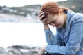 Sad casual woman complaining alone on the beach Royalty Free Stock Photo