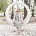 Sad caucasian senior woman sitting on round bench in park. Royalty Free Stock Photo