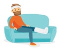 Caucasian man with broken leg sitting on the couch