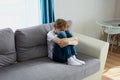 Sad child boy sit crying alone at home Royalty Free Stock Photo