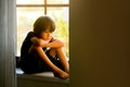 Sad child, boy, sitting on a window shield Royalty Free Stock Photo