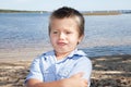 Sad child boy who grimaces in beach vacation spring Royalty Free Stock Photo