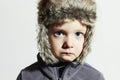Sad child in fur Hat.Kids casual winter style.little boy.children emotion Royalty Free Stock Photo