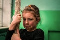 Sad child holds a rope in the gym. Portrait of a crying little girl in a black sports leotard. A schoolgirl doesnÃ¢â¬â¢t get to climb Royalty Free Stock Photo