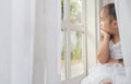 Depressed Little girl near window at home Royalty Free Stock Photo