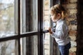 Sad child looking out the window Royalty Free Stock Photo