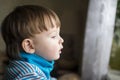 Sad child looking out of the window. Royalty Free Stock Photo