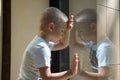 Sad child near window Royalty Free Stock Photo