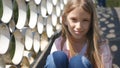 Sad Child in Park, Unhappy Thoughtful Girl Outdoor, Bored Pensive Kid on Bridge Royalty Free Stock Photo