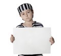 Sad child with prisoner costume and blank poster