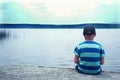 Sad child sitting alone Royalty Free Stock Photo