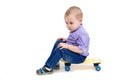 Sad child sitting on a skateboard Royalty Free Stock Photo