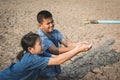 Sad children want to drink some water on crack ground Royalty Free Stock Photo