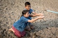 Sad children want to drink some water on crack ground Royalty Free Stock Photo