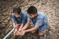 Sad children want to drink some water on crack ground Royalty Free Stock Photo