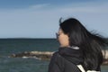 A sad chinese woman looking out at the ocean Royalty Free Stock Photo