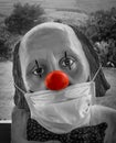 Sad clown with red nose wearing protective mask Royalty Free Stock Photo