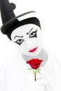 Sad clown with red rose