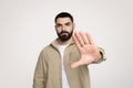 Sad confident attractive young latin guy with beard in casual make hand stop gesture Royalty Free Stock Photo