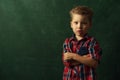 Sad confused little boy stands in dark corner Royalty Free Stock Photo