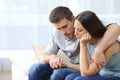 Sad couple comforting each other at home Royalty Free Stock Photo
