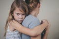 Sad daughter hugging his mother at home. Royalty Free Stock Photo