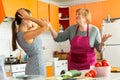 Daughter and mother swearing in kitchen