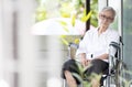 Sad and depressed asian senior woman sitting alone in wheelchair with head down feel lonely and bored,disabled old elderly with