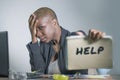 Sad and depressed black afro American woman suffering stressed at office working with laptop computer feeling overwhelmed asking f Royalty Free Stock Photo