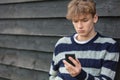 Sad Depressed Boy Male Child Teenager Using Mobile Cell Phone