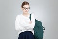 Sad depressed girl student in glasses standing with hands folded Royalty Free Stock Photo