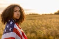 Sad Depressed Girl Woman Teenager Wrapped in USA Flag at Sunset Royalty Free Stock Photo