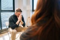 Sad depressed male talking with compassionate patients and psychotherapist sitting in circle during group interpersonal Royalty Free Stock Photo