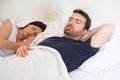 Sad and depressed man lying in the bed with wife