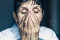 Sad depressed, stressed, thoughtful, senior, middle aged old woman, gloomy, worried, covering her face. Human expressions, emotion Royalty Free Stock Photo