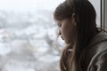 Sad Depressed Teen Girl sitting Alone and Depressed on the windowsill. Unhappy teenager Royalty Free Stock Photo