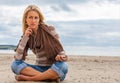 Sad Depressed Thoughtful Young Woman Girl Listening to Music on a Beach Royalty Free Stock Photo