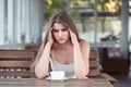 Sad and depressed woman alone in a lonely bar after a break up Royalty Free Stock Photo