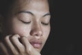 Sad depressed woman suffering and from family life. women sitting in dark room and crying, Young beautiful women thinking how to