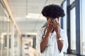 Sad and depressed young african american female doctor in white uniform standing in corridor Royalty Free Stock Photo